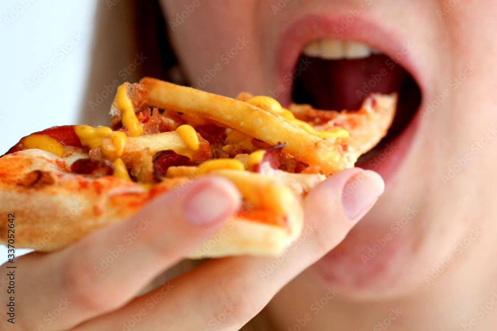 Woman eats pizza, of mischievous calories and harmful cholesterol. Woman eats pizza, of mischievous calories and harmful cholesterol.