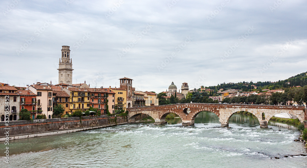 View  of the Adige river, embankments, Ponte Pietra and Verona Cathedral in the old part of Verona city, Italy.