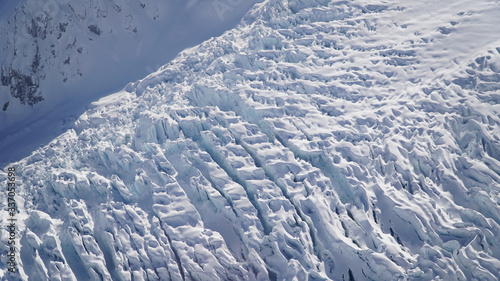 Snow covered Franz Josef and Fox Glaciers on a sunny day near Waiau on the South Island of New Zealand. photo