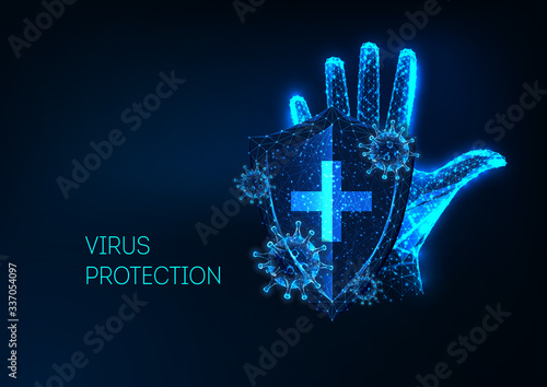 Futuristic Coronavirus protection concept with glowing low polygonal human hand, shield and viruses