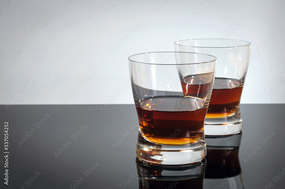 Two glasses of whiskey on a black table Two glasses of whiskey on a black table