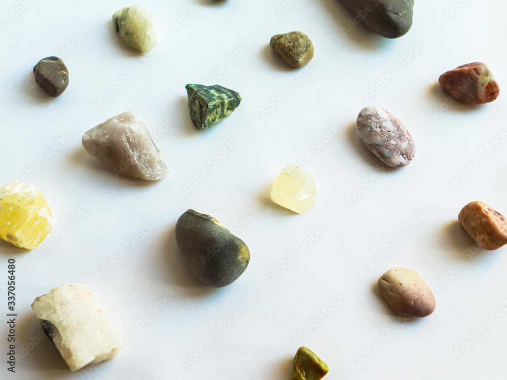 Collection of multi colored stones on white background Collection of multi colored stones on white background