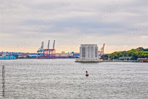 Brooklyn-Battery Tunnel Ventilation Building near Governors Island during the gloomy weather from The Staten Island Ferry, New York.