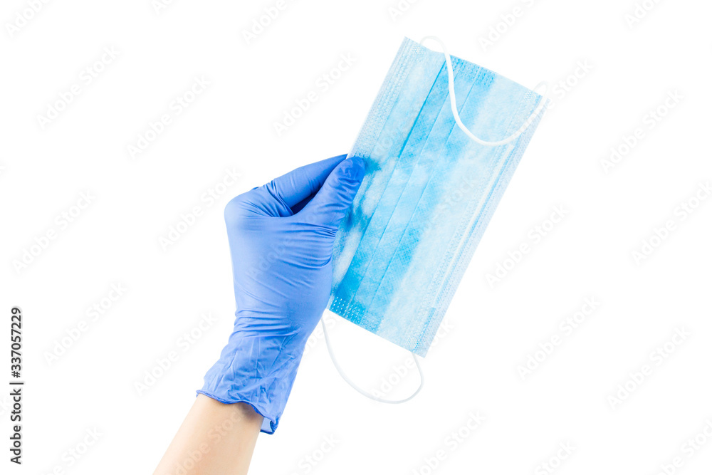 Protective medical mask in hand, isolated on white Protective medical mask in hand, isolated on white
