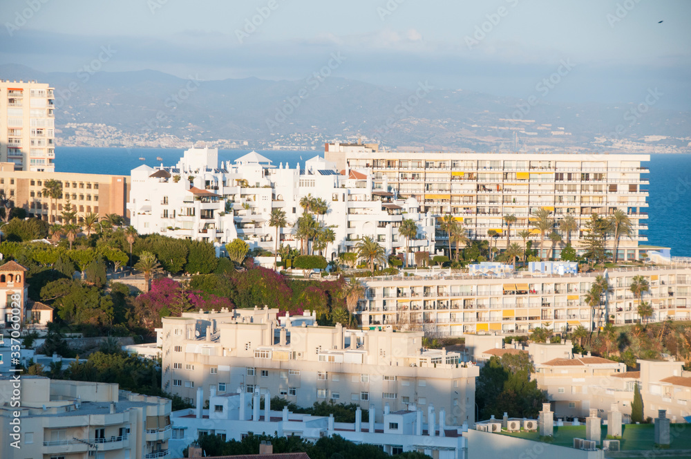 White buildings on the Mediterranean coast. Spanish tourist town on a hill near the sea. Mediterranean architecture.