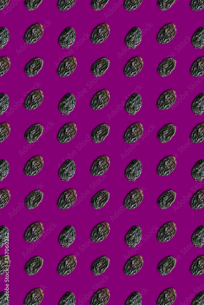 Seamless pattern on a purple background raisins background. Top view.