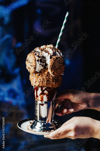 Cookies shake in graffiti place. Extravagant and crazy milkshake with ice cream and chocolate. Special for kids. Insane dessert. Famous in America. Full of calories.