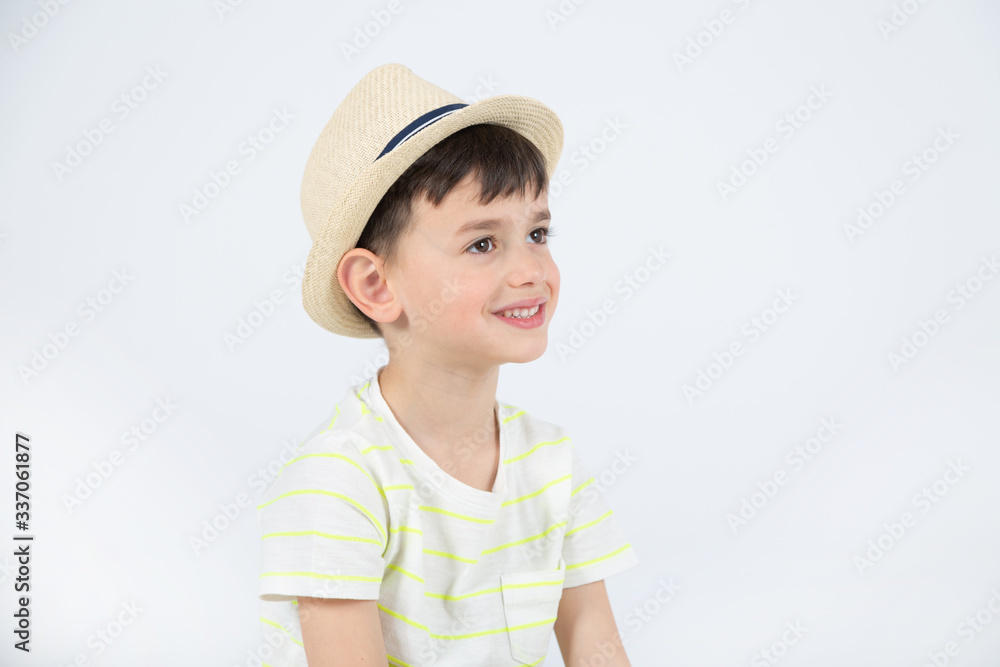 emotional boy in summer hat looking aside isolated emotional boy in summer hat looking aside isolated