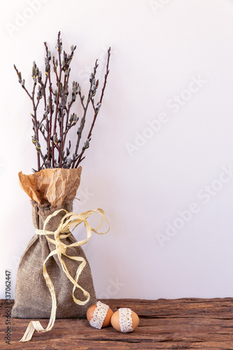 Beautiful easter card. Bouquet of willow with ribbons and burlap on a white background.
