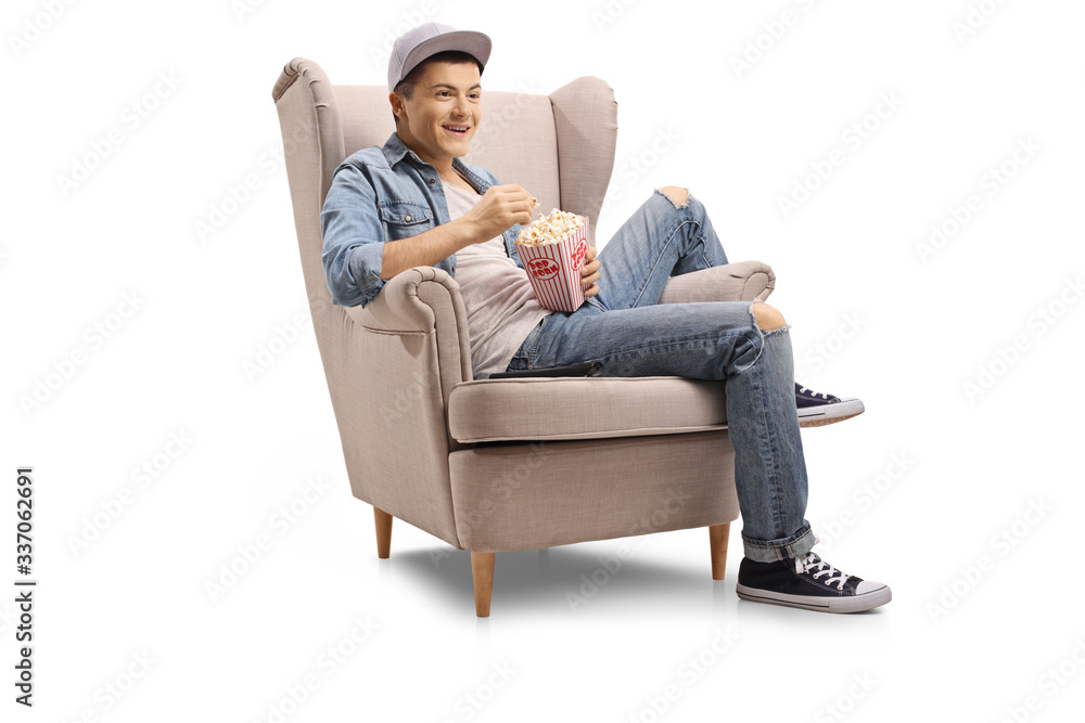 Guy seated in an armchair with a box of popcorn Guy seated in an armchair with a box of popcorn