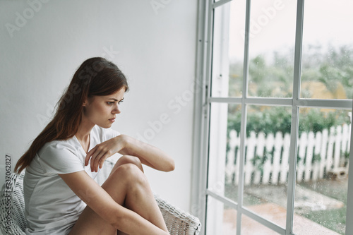 young woman looking at window