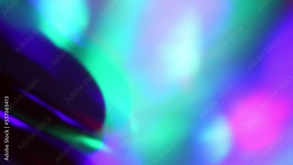 Seamless loop of blurred rotating colorful LED lights and moving hand shadow Seamless loop of blurred rotating colorful LED lights and moving hand shadow