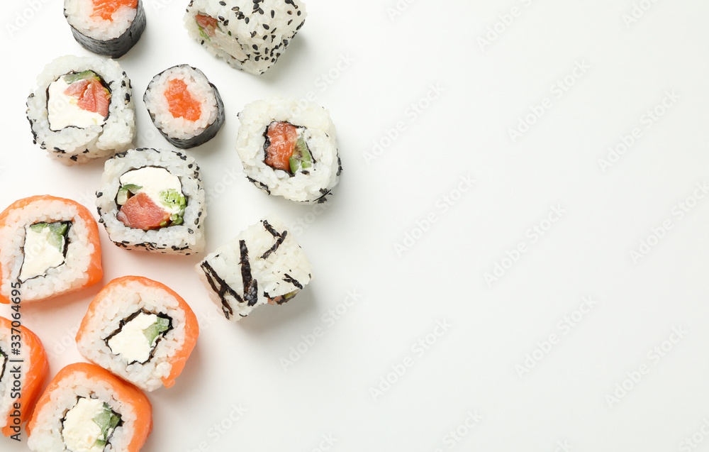 Delicious sushi rolls on white background, top view. Japanese food Delicious sushi rolls on white background, top view. Japanese food