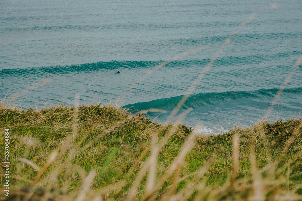 Magical view of the Atlantic Ocean with Waves and some Surfers. Sea views from above of a hill Magical view of the Atlantic Ocean with Waves and some Surfers. Sea views from above of a hill