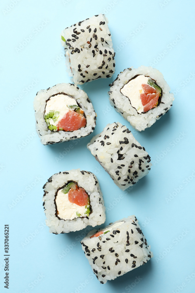 Delicious sushi rolls on blue background. Japanese food Delicious sushi rolls on blue background. Japanese food