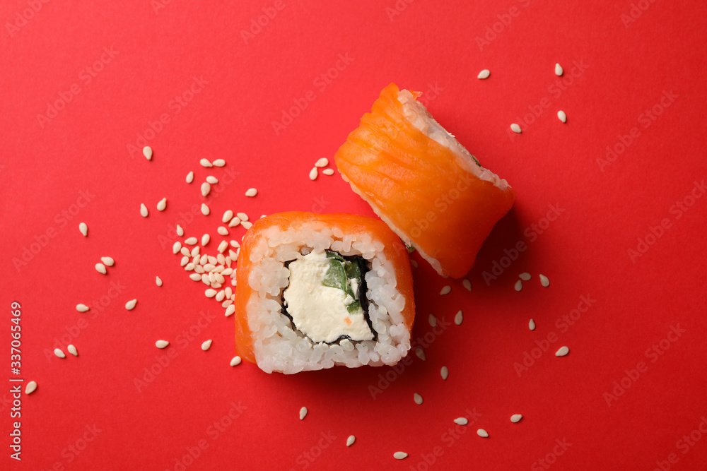 Delicious sushi rolls on red background. Japanese food Delicious sushi rolls on red background. Japanese food