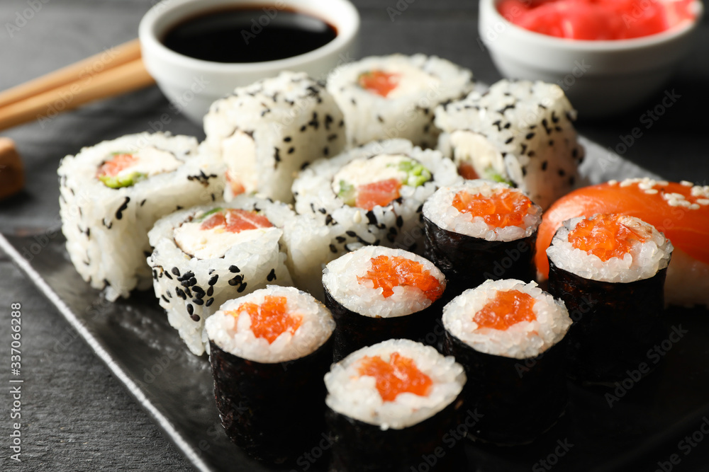 Tray with delicious sushi rolls, close up. Japanese food Tray with delicious sushi rolls, close up. Japanese food
