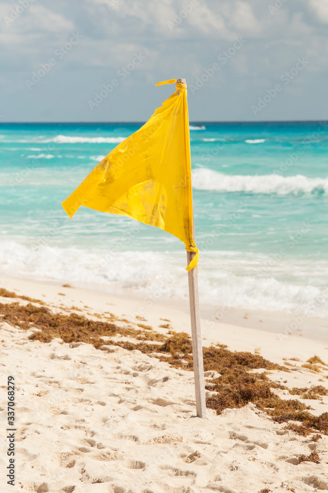 yellow flag on the beach Stock Photo | Adobe Stock