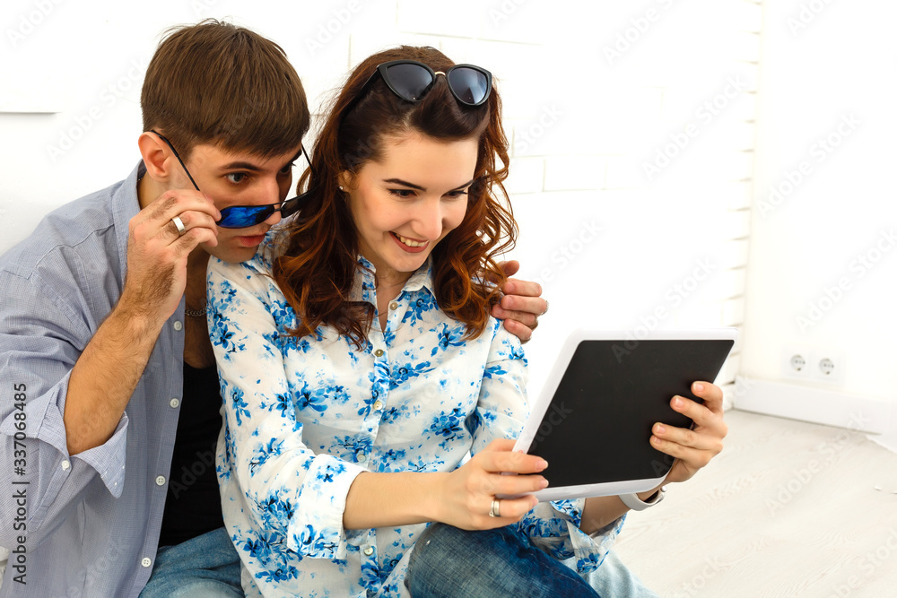 Happy young couple doing shopping on internet
