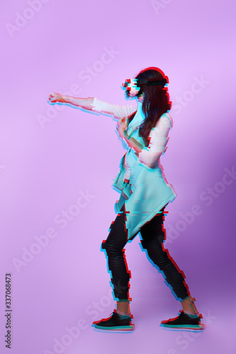 Woman is using virtual reality headset. Image with glitch effect. © nuclear_lily
