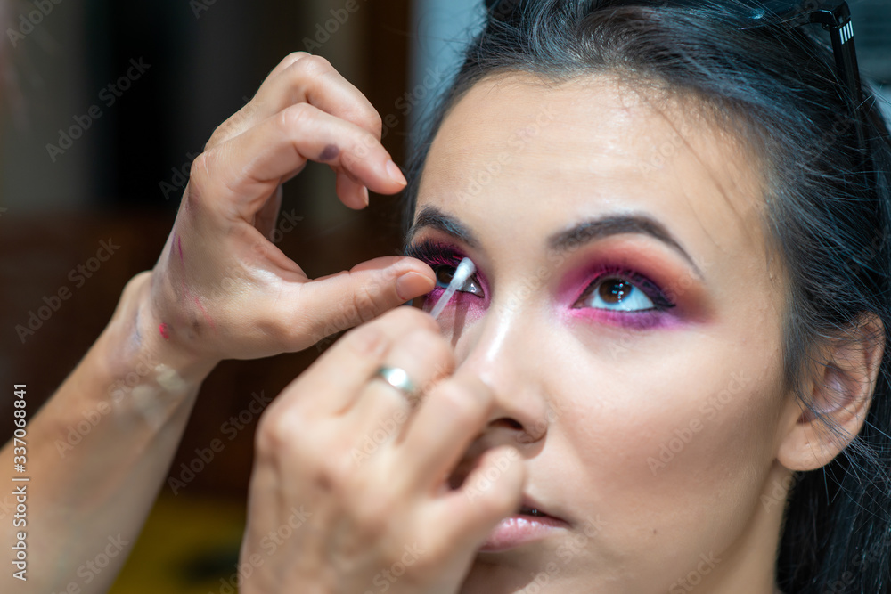 Makeup artist applying false eyelash.Make up artist doing professional make up of beautiful young woman. Makeup artist applying false eyelash.Make up artist doing professional make up of beautiful young woman.
