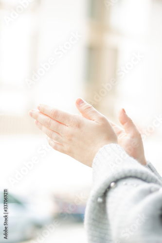 Spanish woman applauding through the window, in recognition of Spanish doctors, nurses and health workers during the coranavirus crisis in Spain, covid-19, concept, selective focus photo