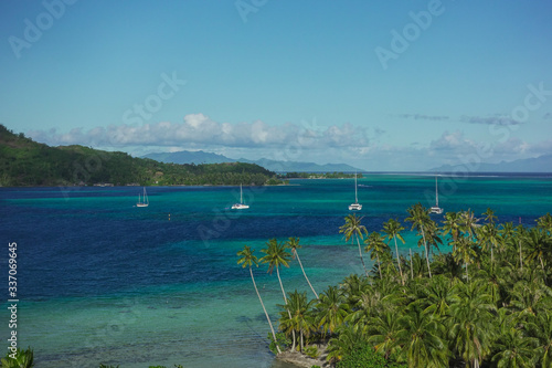 Fototapeta Sailboats Off the Coast in Turquoise Pacific Ocean in Bora  Bora French Polynesi