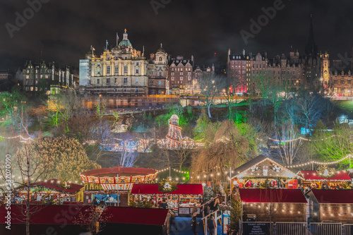 Christmas Market at Edinburgh, Scotland. Night lights lit up setting a lovely scene against the night sky.