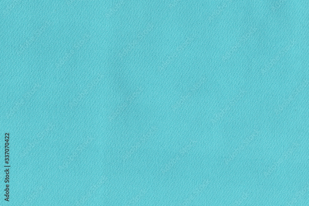 Turquoise soft fabric. The texture of the plain fabric for the dress