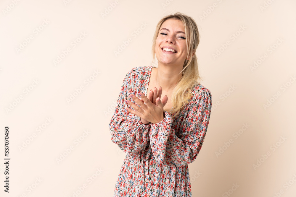 Blonde woman over isolated background applauding after presentation in a conference Blonde woman over isolated background applauding after presentation in a conference