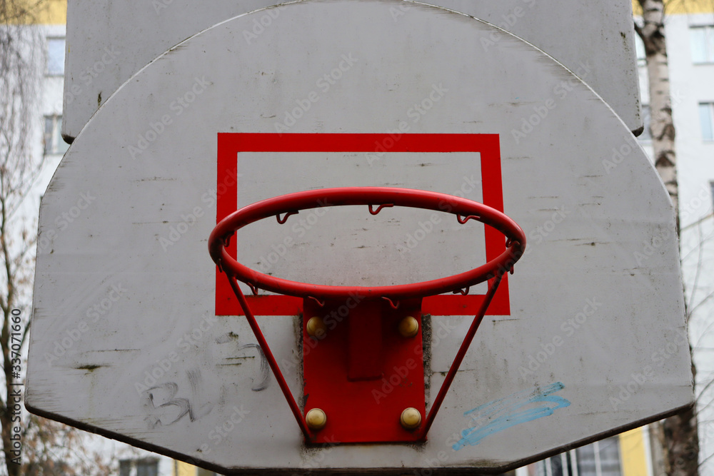 Outdoor basketball hoop with torn net bottom view