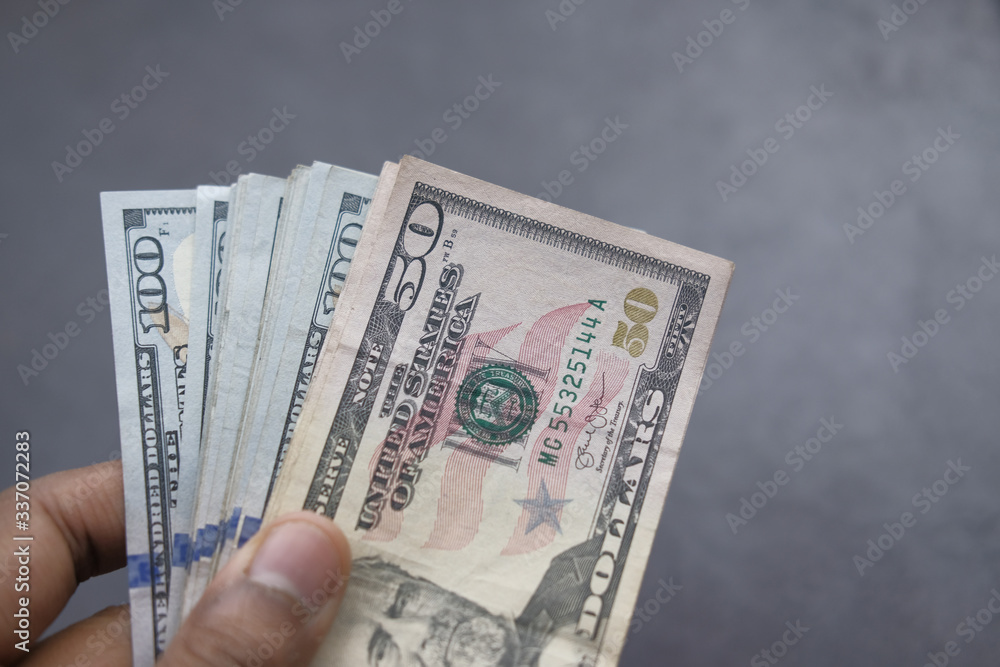 Man's hands holding hundred dollar bills. Business concept. Man's hands holding hundred dollar bills. Business concept.