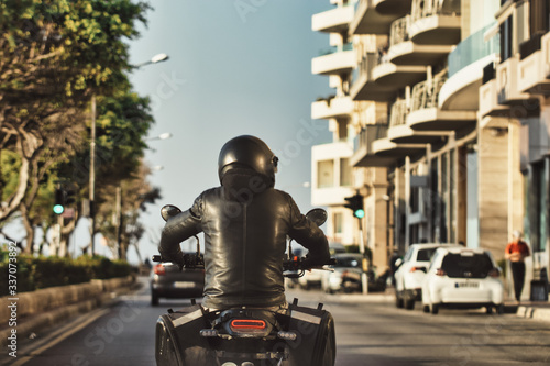 Motorcycle Rider In The Corner From Behind photo