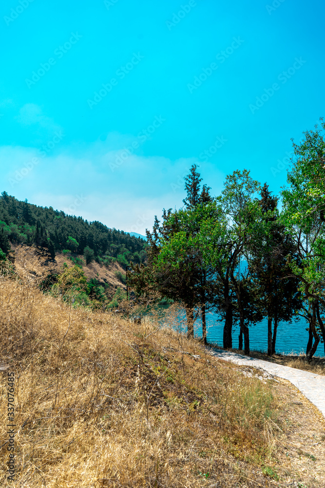 Beautiful blue sky, trees, mountain and trail in UNESCO WHS Ohrid, North Macedonia. August, 2019 Beautiful blue sky, trees, mountain and trail in UNESCO WHS Ohrid, North Macedonia. August, 2019