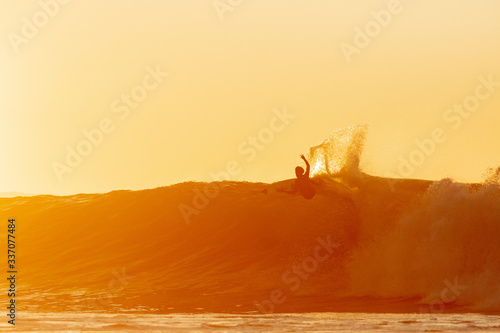 silhouette of a surfer on a wave.