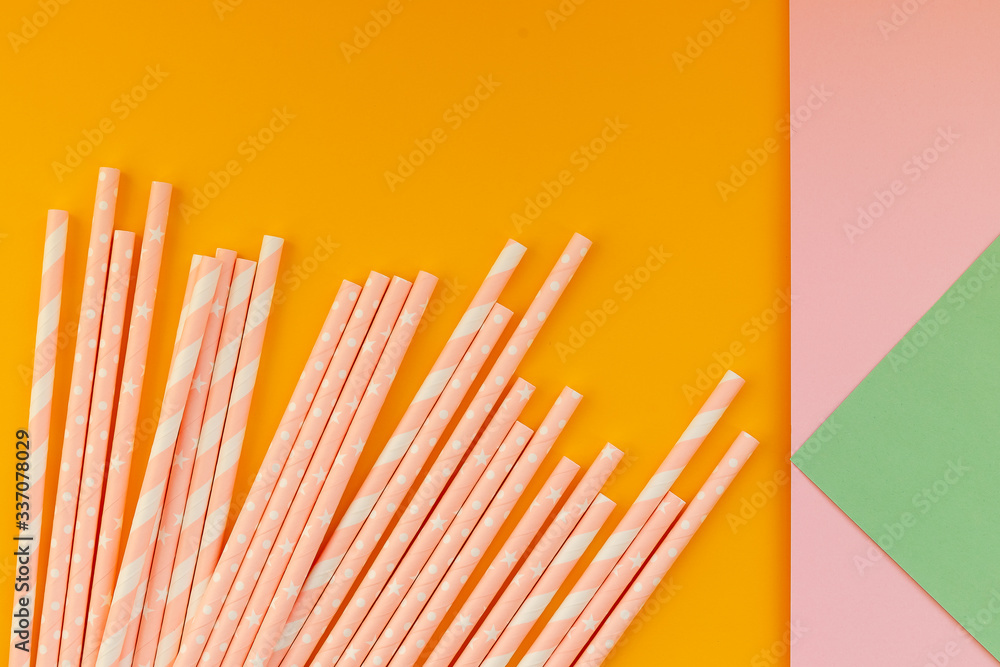 paper drinking straws on yellow,colorful background. Zero waste nature friendly biodegradable materials. Birthday party holiday celebration background.Copy space paper drinking straws on yellow,colorful background. Zero waste nature friendly biodegradable materials. Birthday party holiday celebration background.Copy space