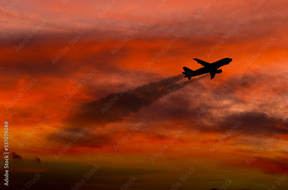 Airplane taking off at sunset. Silhouette of a big passenger or cargo aircraft, airline. Transportation.