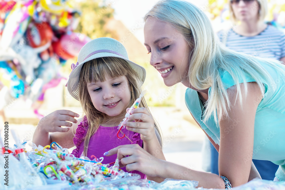 Lovely mother and daughter having fun at a festival Lovely mother and daughter having fun at a festival