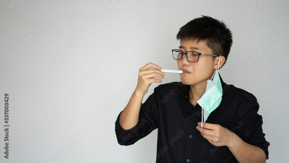 The man wearing face hygienic mask for prevention global covid-19 virus pandemic. Look at thermometer symptops maby sick or illness from virus.
The man wearing face hygienic mask for prevention global covid-19 virus pandemic. Look at thermometer symptops maby sick or illness from virus.
