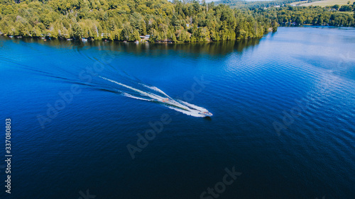 Fototapeta Naklejka Na Ścianę i Meble -  Boat Pulling Tubes on Lake