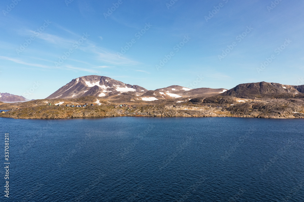 Beautiful Greenlandic shoreline. Views of green mountains in the background