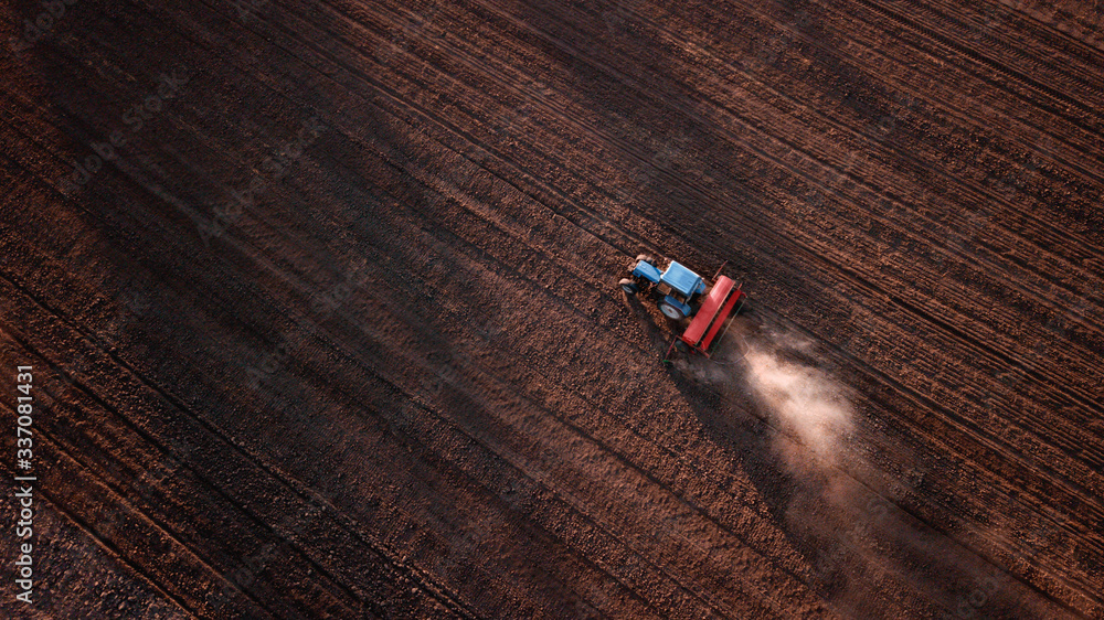 aerial view of tractor , combine cultivating field. drone shot. picture with space for text. Farmland from above aerial view of tractor , combine cultivating field. drone shot. picture with space for text. Farmland from above