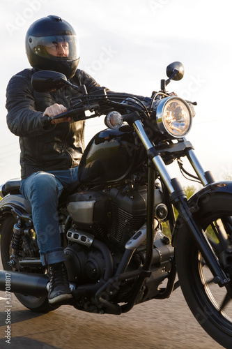 Man riding motorbike along countryside road photo