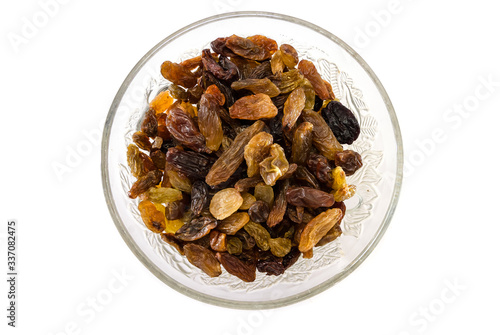 Long light raisins in a plate isolated on a white background. Natural product. View from above.