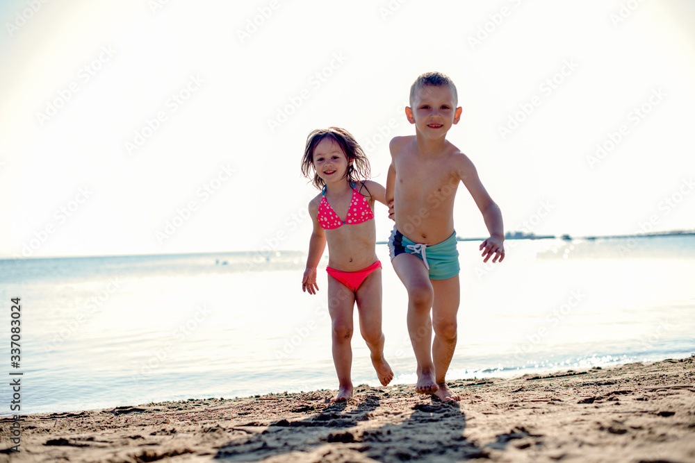 Kids walking on a beach Kids walking on a beach