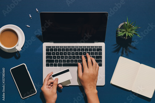 Asian man hand shopping online with credit card photo