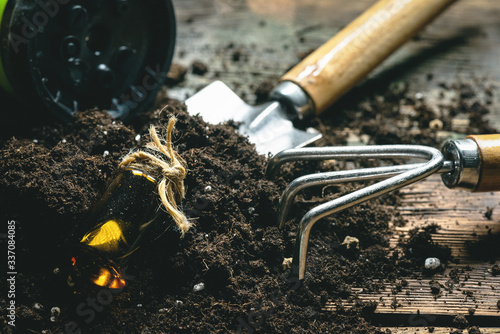 Garden soil, fertilizer and garden tools close up. photo
