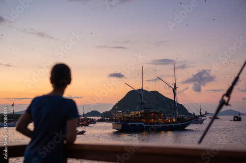 Sunset with hundreds of fruit bats over Komodo photo