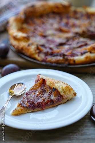 almond plum cake on puff pastry. Delicious piece of cake.