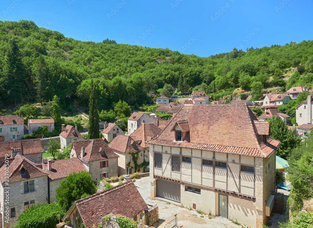 Landscape view of the typical houses and roofs of Saint-Cirq-Lapopie, one of the most beautiful villages in France (Plus Beaux Villages de France), Lot River valley, Causses du Quercy Natural Park
